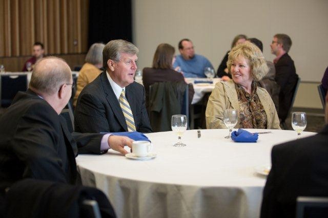 President Emeritus Thomas J. Haas sitting and having a conversation with others